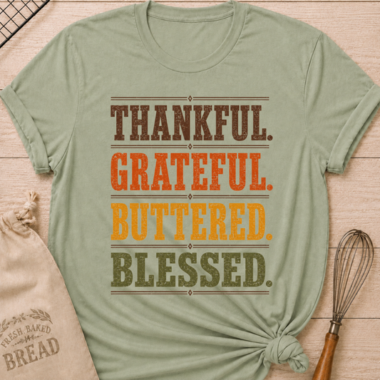Sage women's relaxed fit tee with bold distressed Thankful Grateful Buttered Blessed lettering stacked in warm harvest brown, orange, gold and olive