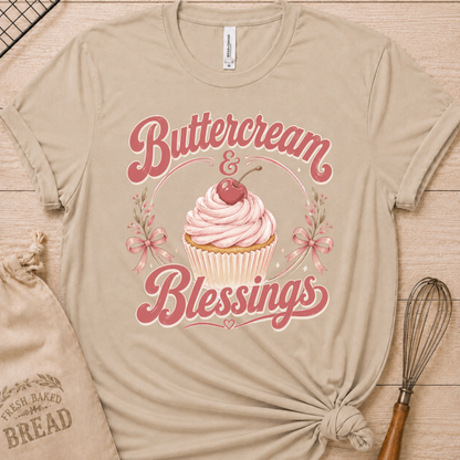 Heather stone women's relaxed fit t-shirt reading Buttercream and Blessings with a frosted cupcake illustration.