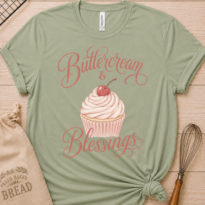 Sage green women's relaxed fit t-shirt reading Buttercream and Blessings with a frosted cupcake and a delicate bow.
