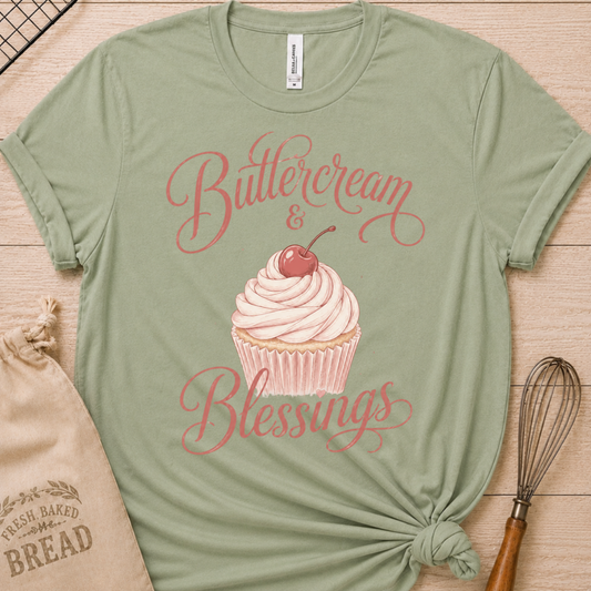 Sage green women's relaxed fit t-shirt reading Buttercream and Blessings with a frosted cupcake and a delicate bow.