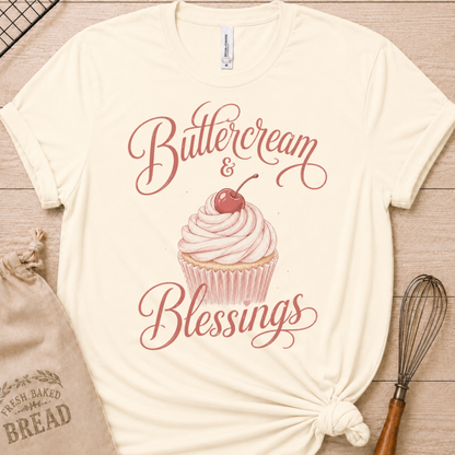 Natural cream women's relaxed fit t-shirt reading Buttercream and Blessings with a frosted cupcake and a delicate bow.