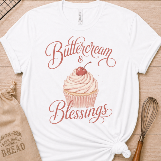 White women's relaxed fit t-shirt reading Buttercream and Blessings with a frosted cupcake and a delicate bow.