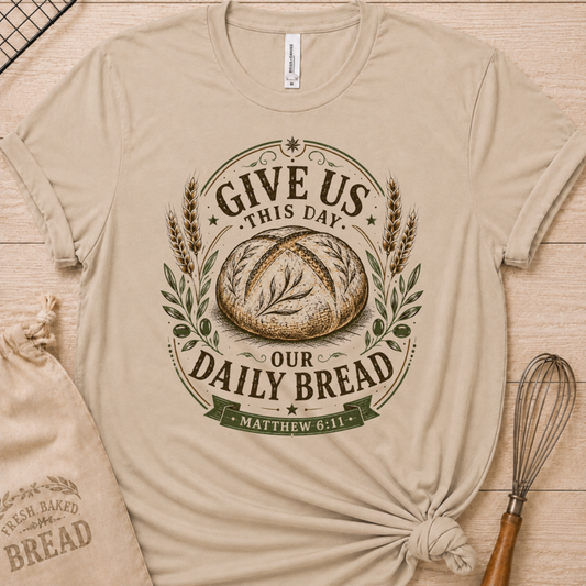 Heather stone women's relaxed fit t-shirt with the Daily Bread emblem, a clean badge-style bread illustration inspired by Matthew 6:11.
