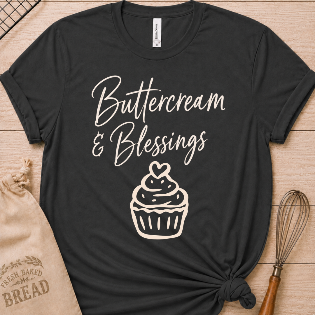 Dark heather grey women's relaxed fit t-shirt with Buttercream and Blessings in flowing script above a cupcake topped with a heart.