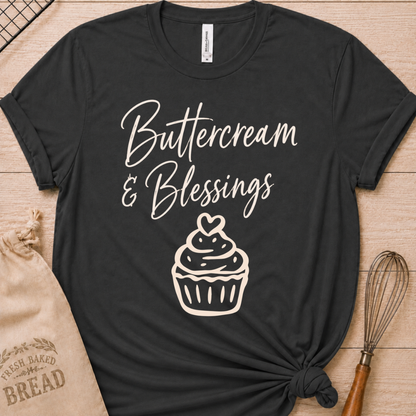 Dark heather grey women's relaxed fit t-shirt with Buttercream and Blessings in flowing script above a cupcake topped with a heart.