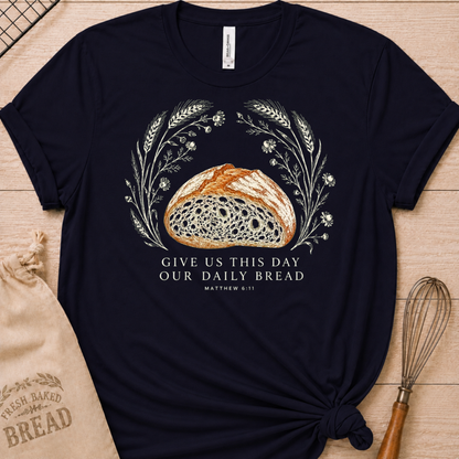 Navy women's relaxed fit t-shirt with the Daily Bread design featuring a rustic loaf of bread wreathed in wheat and flowers, inspired by Matthew 6:11.