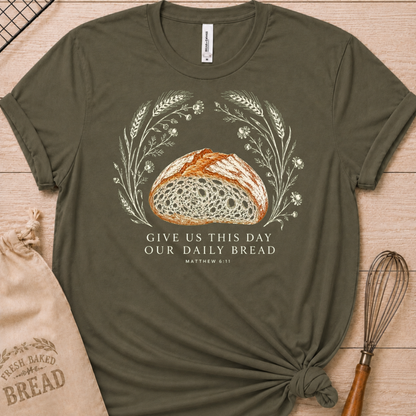 Military green women's relaxed fit t-shirt with the Daily Bread design featuring a rustic loaf of bread wreathed in wheat and flowers, inspired by Matthew 6:11.