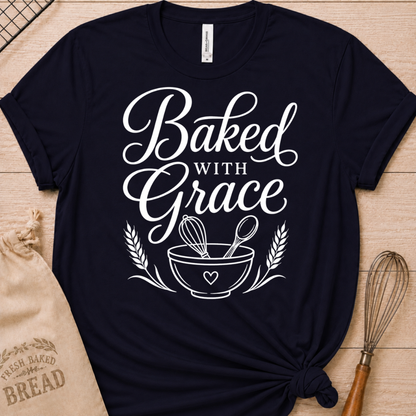 Navy women's relaxed fit t-shirt with Baked with Grace in white script above a mixing bowl with a whisk and wooden spoon.