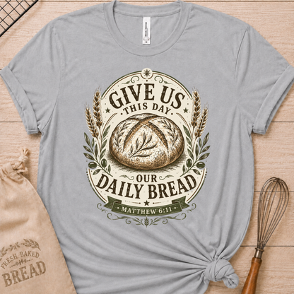Athletic heather women's relaxed fit t-shirt with the Daily Bread emblem printed in cream, a clean badge-style bread illustration inspired by Matthew 6:11.