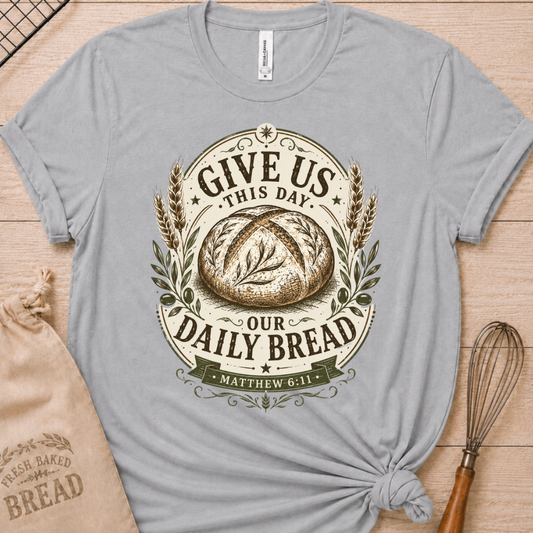 Athletic heather women's relaxed fit t-shirt with the Daily Bread emblem printed in cream, a clean badge-style bread illustration inspired by Matthew 6:11.