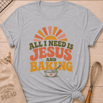 Athletic Heather All I Need Is Jesus and Baking women's relaxed fit tee with bold retro lettering, a rising sun, mixing bowl, and whisk