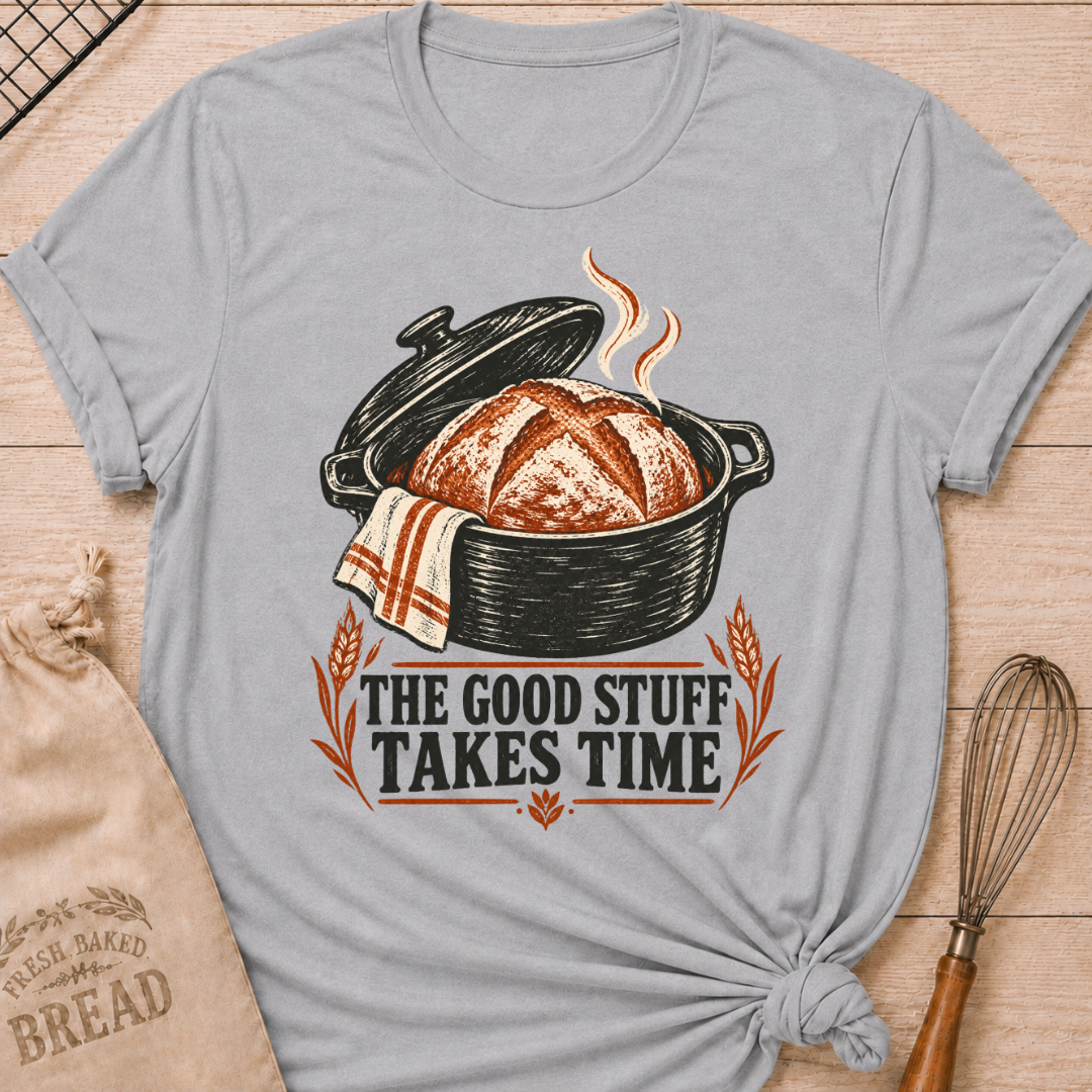 Athletic Heather women's relaxed fit tee with a warm artisan loaf rising from a classic Dutch oven with wheat accents and vintage distressed Good Stuff Takes Time lettering