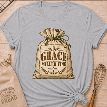 Athletic Heather women's relaxed fit tee with a vintage flour sack tied with rope, detailed with wheat motifs, Grace Milled Fine lettering and Psalm 145:15
