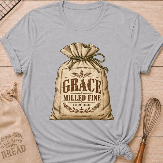 Athletic Heather women's relaxed fit tee with a vintage flour sack tied with rope, detailed with wheat motifs, Grace Milled Fine lettering and Psalm 145:15