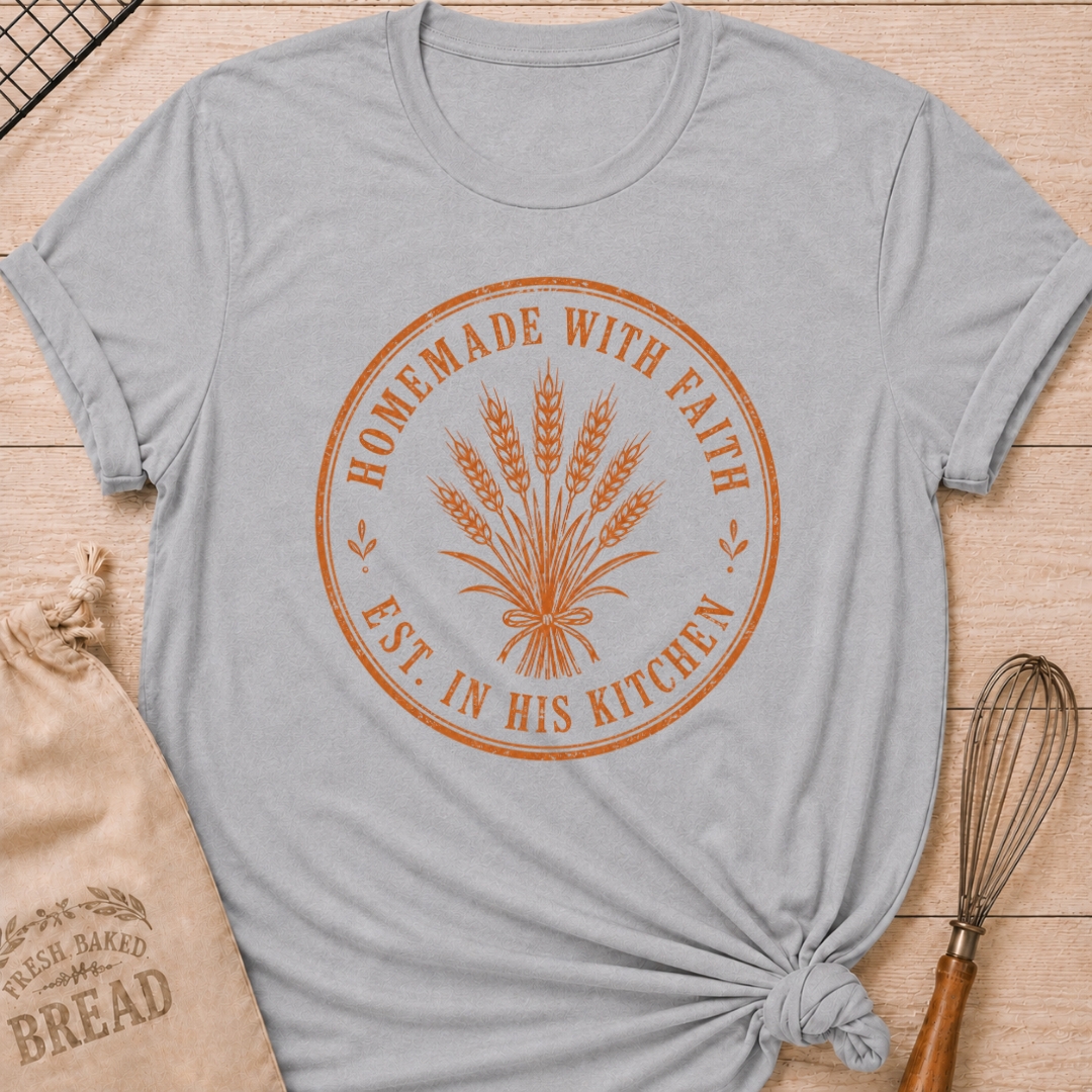 Athletic heather women's relaxed fit t-shirt with the words Homemade with Faith in a vintage market emblem around a tied bundle of wheat.