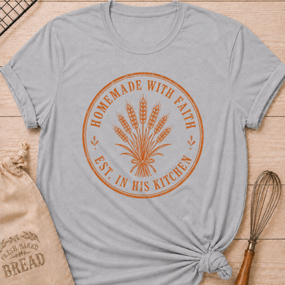 Athletic heather women's relaxed fit t-shirt with the words Homemade with Faith in a vintage market emblem around a tied bundle of wheat.