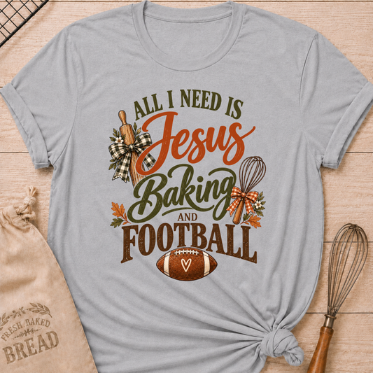 Athletic Heather women's relaxed fit tee with bold vintage All I Need Is Jesus Baking and Football lettering, a rolling pin, whisk, gingham bows, autumn leaves and a classic football