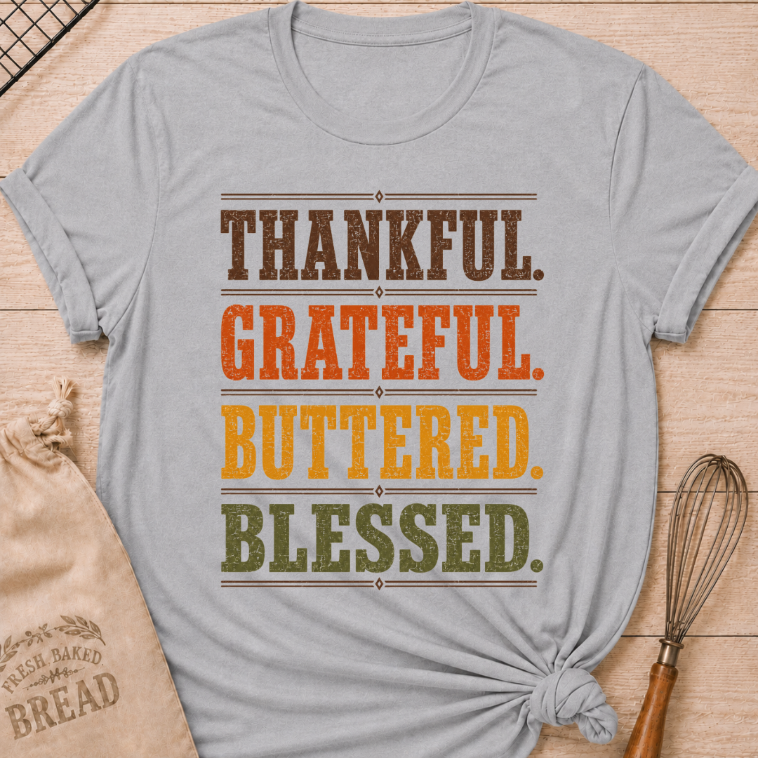 Athletic Heather women's relaxed fit tee with bold distressed Thankful Grateful Buttered Blessed lettering stacked in warm harvest brown, orange, gold and olive