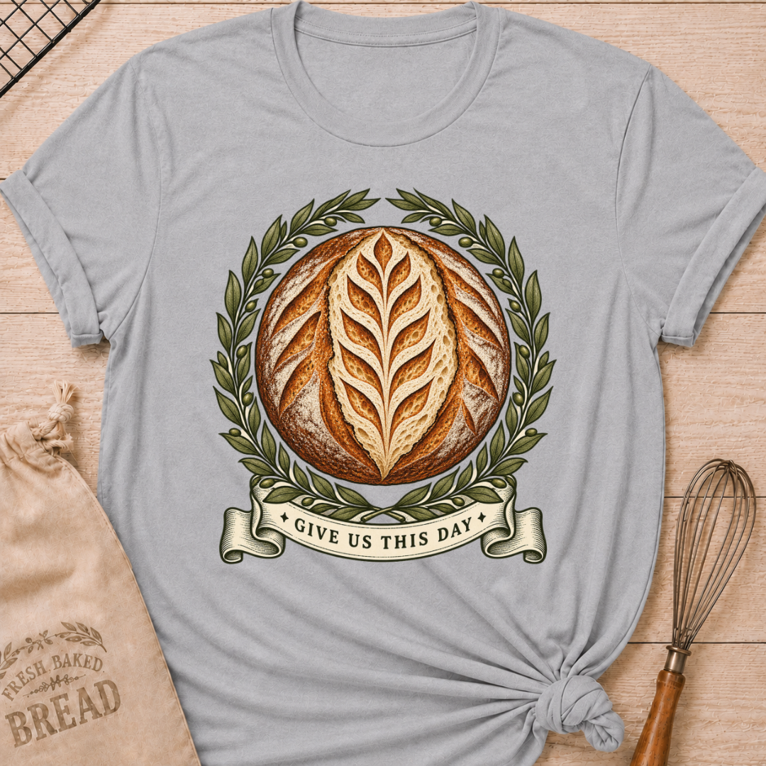 Athletic Heather women's relaxed fit tee with a scored artisan loaf framed by olive branches, finished with a vintage banner reading Give Us This Day
