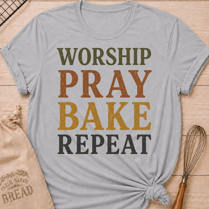 Athletic Heather Worship Pray Bake Repeat women's relaxed fit tee with bold stacked vintage typography in warm retro colors