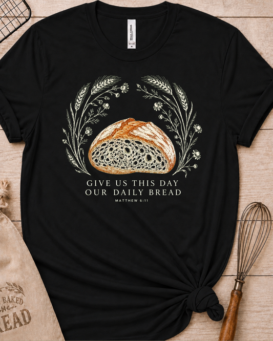 Black women's relaxed fit t-shirt with the Daily Bread design featuring a rustic half loaf of bread, inspired by Matthew 6:11.