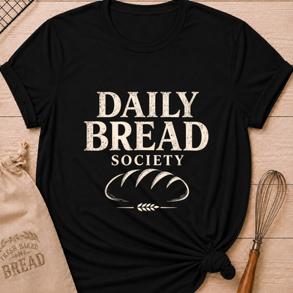 Black women's relaxed fit t-shirt with the words Daily Bread Society in bold vintage lettering above a classic loaf and wheat.