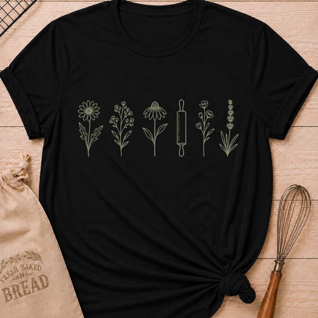 Black women's relaxed fit t-shirt with a classic rolling pin and a row of delicate wildflowers in soft sage and cream.