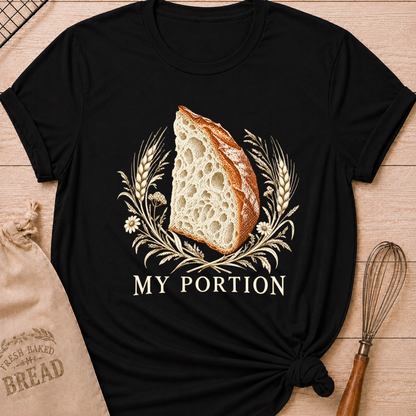 Black women's relaxed fit tee with a detailed slice of artisan bread framed by wheat and delicate wildflowers in warm earthy tones, with My Portion lettering below
