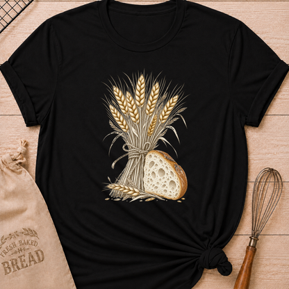 Black women's relaxed fit tee with a hand-tied bundle of golden wheat beside a richly textured slice of artisan bread