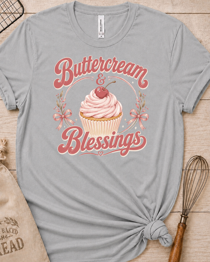 Heather grey women's relaxed fit t-shirt reading Buttercream and Blessings with a frosted cupcake and a delicate bow.