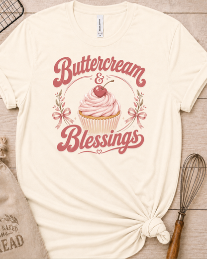 Natural cream women's relaxed fit t-shirt reading Buttercream and Blessings with a frosted cupcake and a delicate bow.