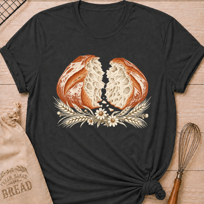 Dark Heather Grey women's relaxed fit tee with a torn artisan loaf showing its airy crumb, framed by wheat and delicate wildflowers