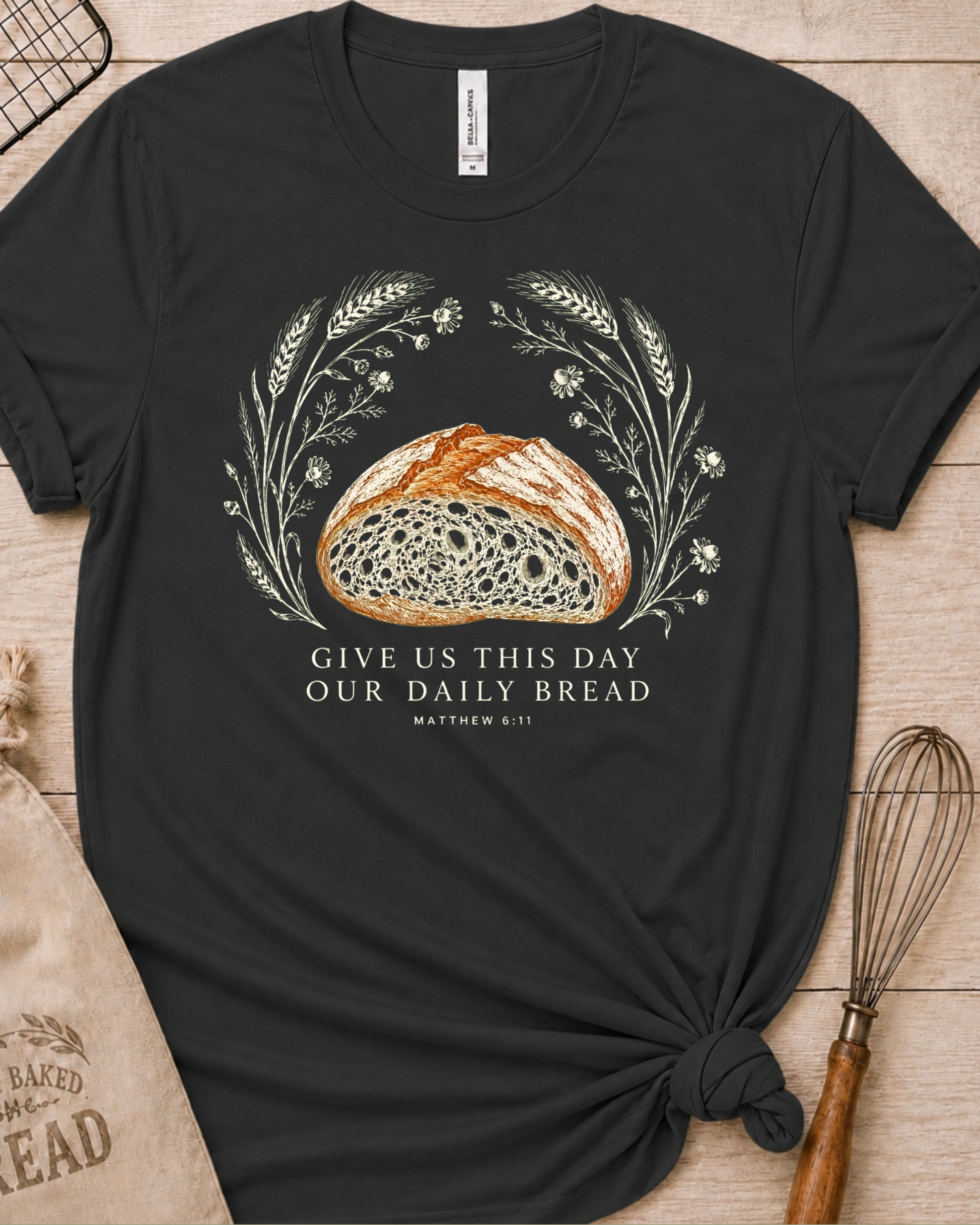 Dark heather grey women's relaxed fit t-shirt with the Daily Bread design featuring a rustic half loaf of bread, inspired by Matthew 6:11.