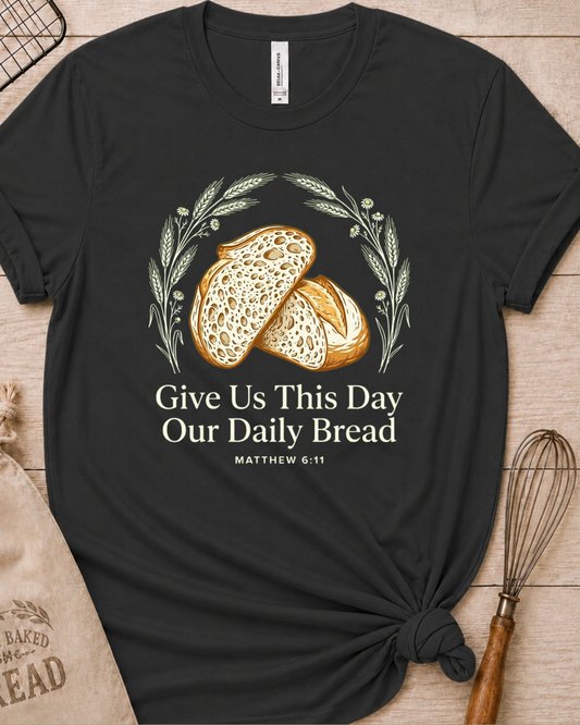 Dark heather grey women's relaxed fit t-shirt with the Daily Bread design featuring two rustic half loaves side by side, inspired by Matthew 6:11.