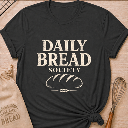 Dark heather grey women's relaxed fit t-shirt with the words Daily Bread Society in bold vintage lettering above a classic loaf and wheat.