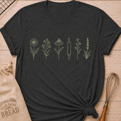 Dark heather grey women's relaxed fit t-shirt with a classic rolling pin and a row of delicate wildflowers in soft sage and cream.