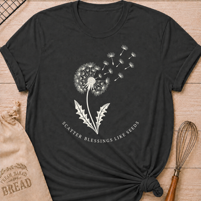 Dark heather grey women's relaxed fit t-shirt with a dandelion releasing its seeds and the words Scatter Blessings Like Seeds.