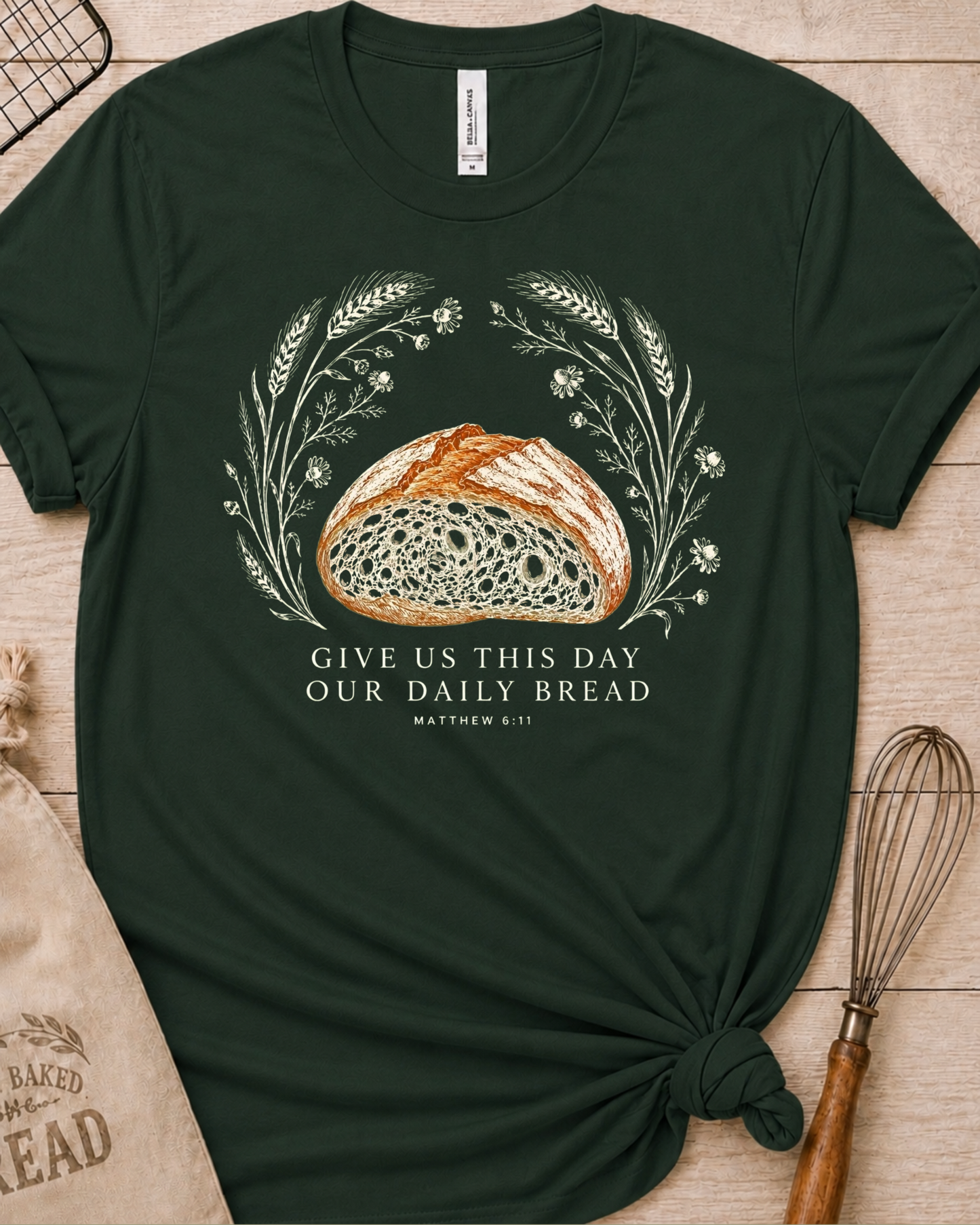 Forest green women's relaxed fit t-shirt with the Daily Bread design featuring a rustic half loaf of bread, inspired by Matthew 6:11.