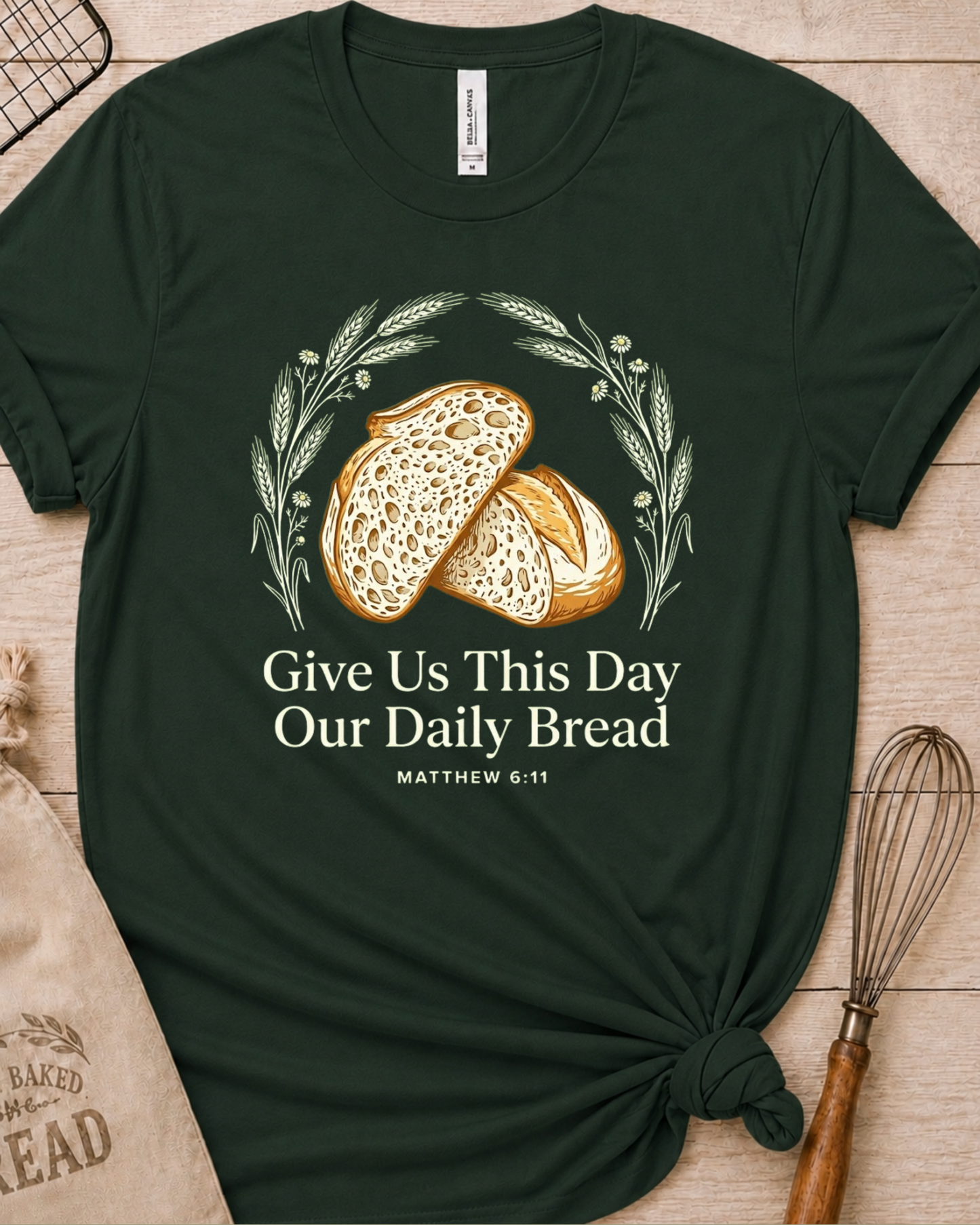 Forest green women's relaxed fit t-shirt with the Daily Bread design featuring two rustic half loaves side by side, inspired by Matthew 6:11.