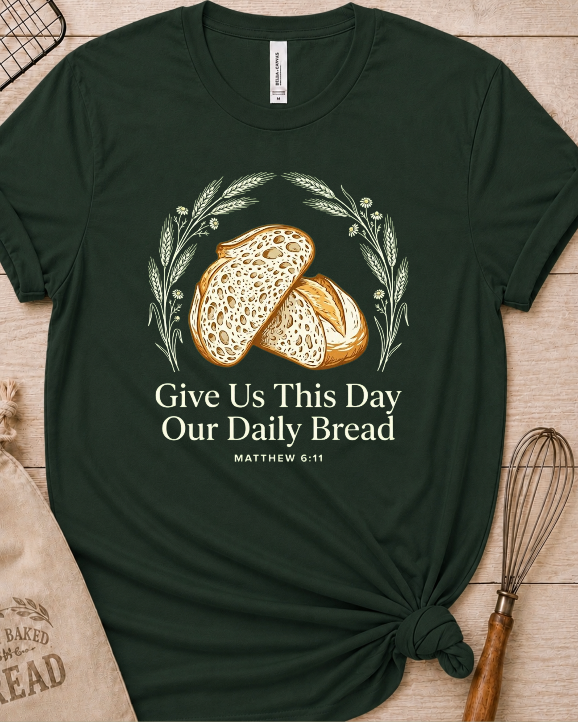Forest green women's relaxed fit t-shirt with the Daily Bread design featuring two rustic half loaves side by side, inspired by Matthew 6:11.