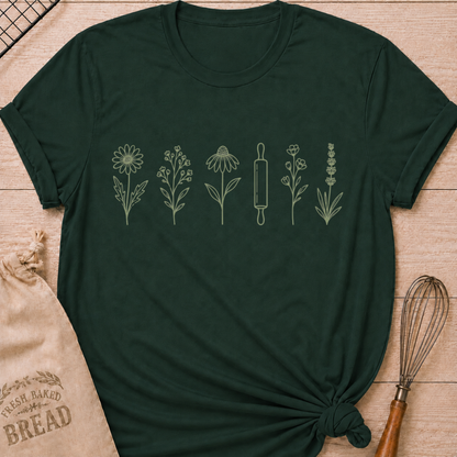 Forest green women's relaxed fit t-shirt with a classic rolling pin and a row of delicate wildflowers in soft sage and cream.