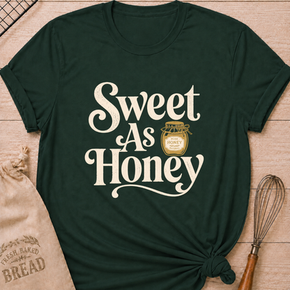 Forest green women's relaxed fit t-shirt with the words Sweet as Honey in playful vintage lettering and a jar of golden honey.