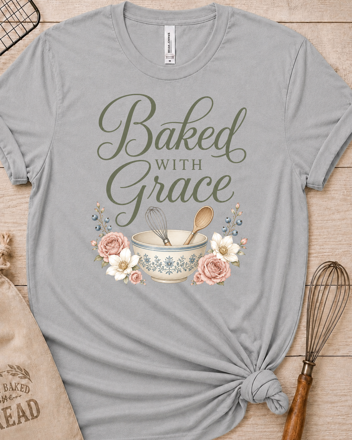 Heather grey women's relaxed fit t-shirt with Baked with Grace in script surrounded by soft blue watercolor florals.