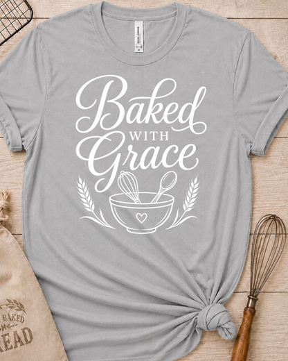 Heather grey women's relaxed fit t-shirt with Baked with Grace in white script above a mixing bowl with a whisk and wooden spoon.
