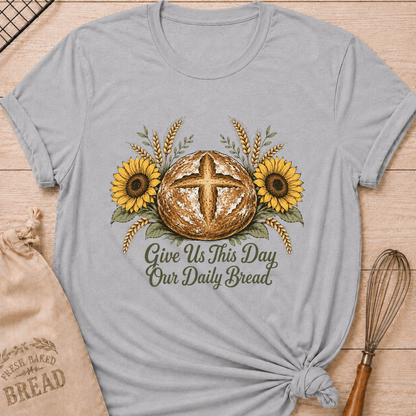 Athletic Heather women's relaxed fit tee with a rustic sourdough loaf, golden wheat, and yellow sunflowers, reading Give Us This Day Our Daily Bread