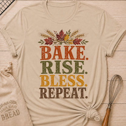 Heather Stone women's relaxed fit tee with distressed vintage Bake Rise Bless Repeat lettering and a tied bundle of wheat and autumn leaves