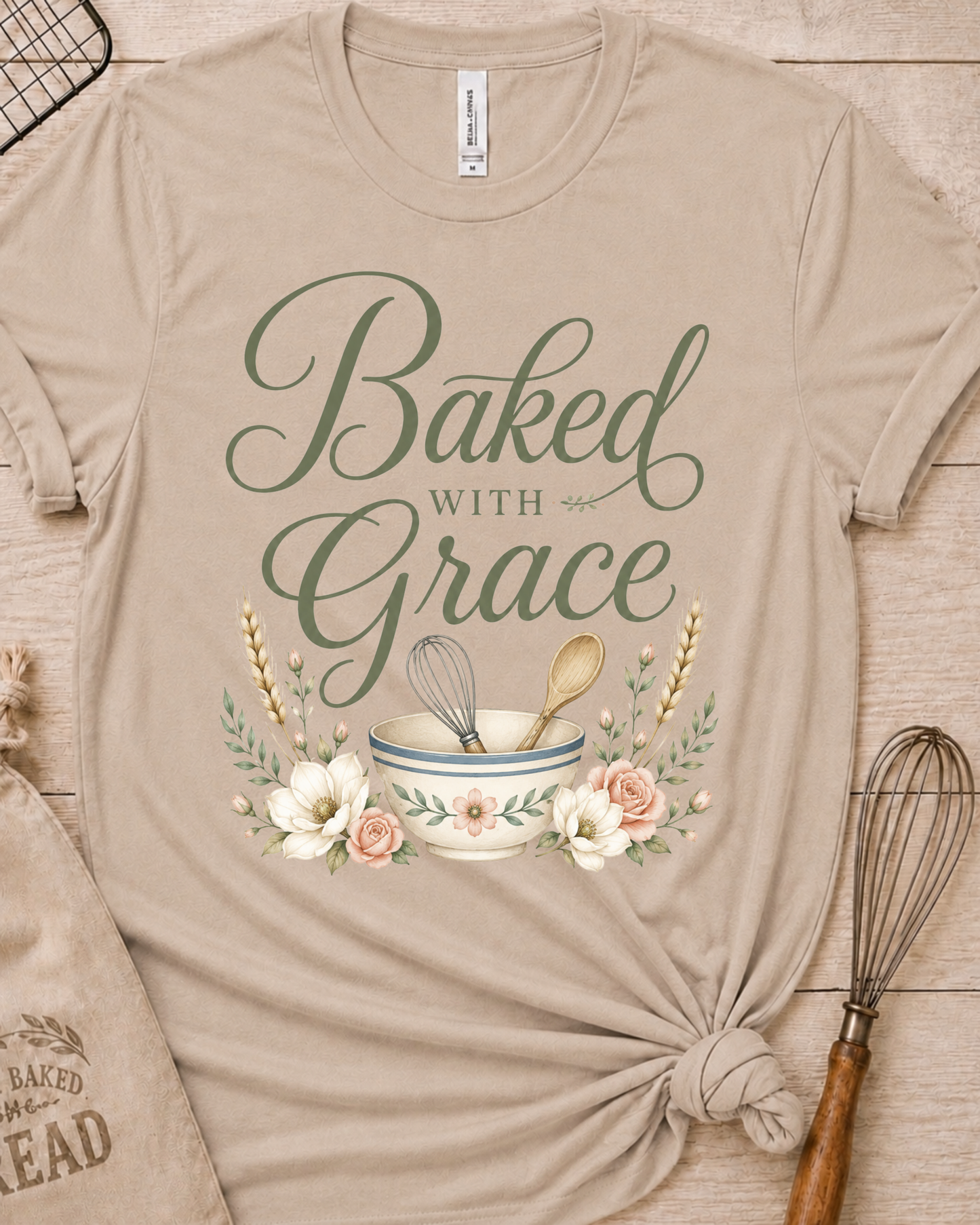 Heather stone women's relaxed fit t-shirt with Baked with Grace in script surrounded by golden wheat stalks and soft watercolor florals.