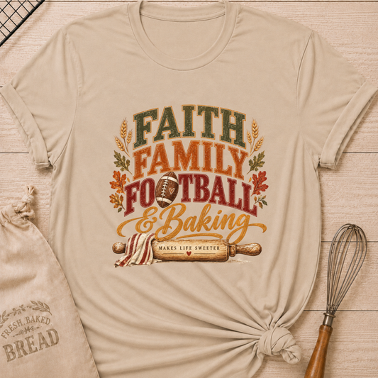 Heather Stone women's relaxed fit tee with vintage collegiate Faith Family Football and Baking lettering above a football and a rolling pin reading Makes Life Sweeter, framed by wheat and autumn leaves
