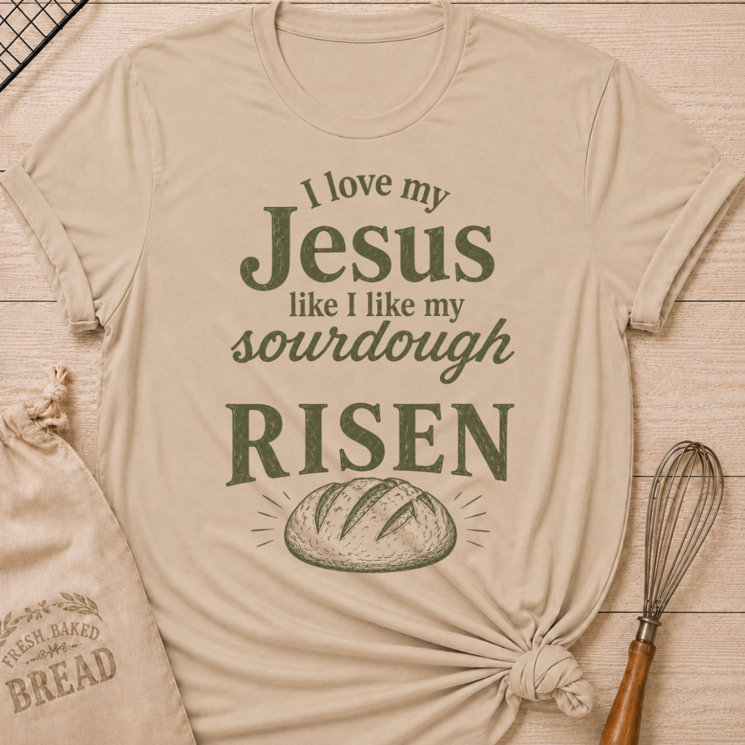 Heather stone women's relaxed fit t-shirt with the words I Love My Jesus Like I Like My Sourdough, Risen in bold vintage lettering and a rustic loaf of bread.