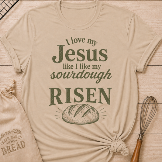 Heather stone women's relaxed fit t-shirt with the words I Love My Jesus Like I Like My Sourdough, Risen in bold vintage lettering and a rustic loaf of bread.